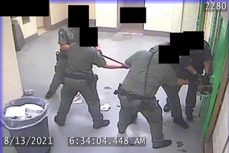 Correction deputies work to remove handcuffs from an inmate during an Aug. 13 incident at the Clark County Jail which is being investigated for “potentially criminal” use of force. 